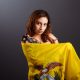 Ethnic Ecuadorian lady with the waving Ecuador flag isolated on gray background..